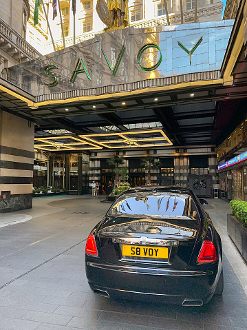 London, England, UK - 23 August 2023: Black limousine with personalised number plate parked in the forecourt of The savoy Hotel in central London