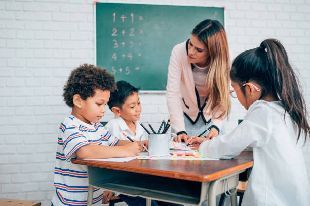 istock Happy school teacher and students having interesting engaging activities in class. 1648658045
