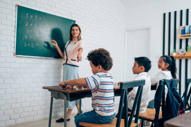 istock Happy school teacher and students having interesting engaging activities in class. 1648662923
