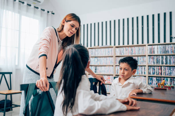 istock Happy school teacher and students having interesting engaging activities in class. 1648666349