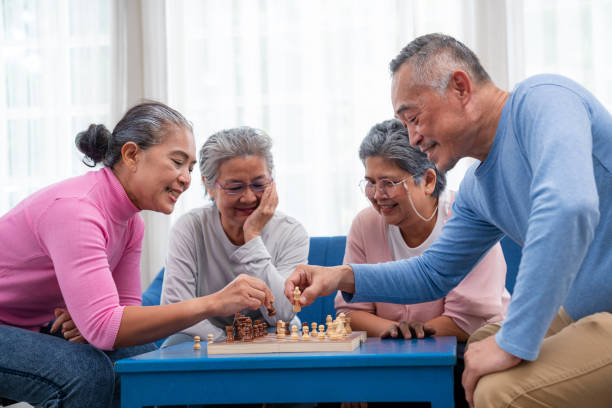 istock Senior old man and woman playing chess game on chess board for strategy. 1648683779