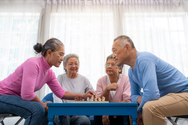 istock Senior old man and woman playing chess game on chess board for strategy. 1648684910