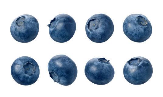 Eight blueberries photographed separately, at different angles.  Blueberries are small, dark blue, edible fruit. The berries are isolated on a white background.