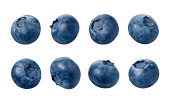 Many different blueberries sitting in a row of 4