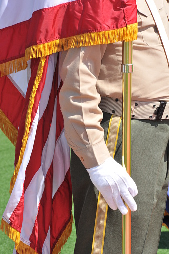 Closeup of A military verteran holding an American Flag