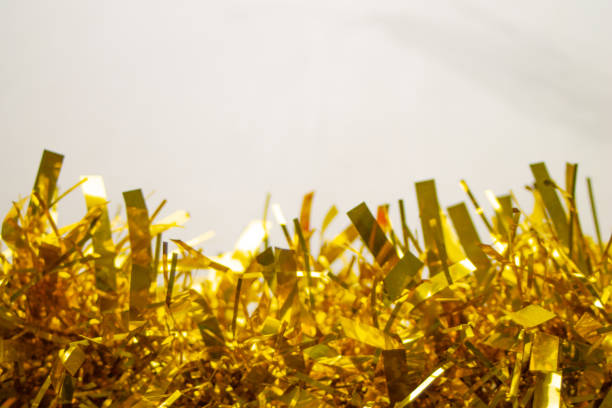 Golden Christmas tinsel in a white background