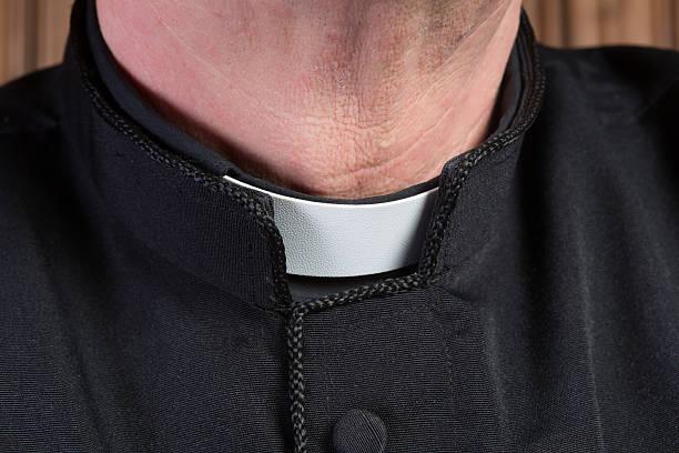 Priest clerical collar Closeup of the neck of a priest wearing a black shirt with cassock and white clerical collar priest photos stock pictures, royalty-free photos & images
