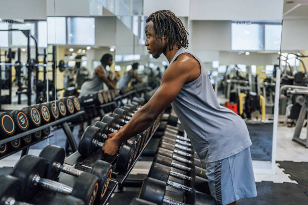 istock Young man taking a dumbbells in a gym 1648716318