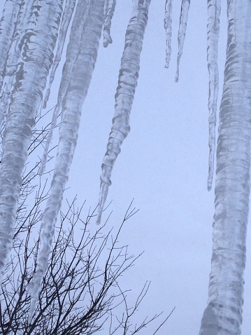 Looking up at large icicles