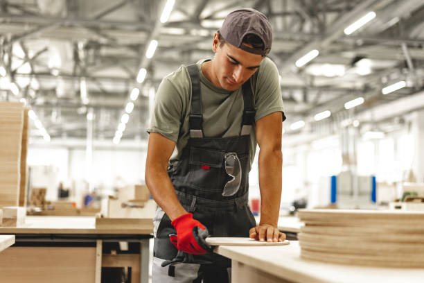 istock Young carpenter making wood furniture while working in joinery 1648725328