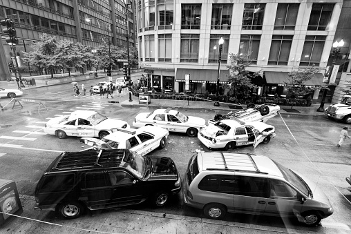 Chicago, Illinois, USA - August 27 - 2012: people looking at five police cars getting involved in a road accident at crossroad between W Randolph st. and N Dearborn st. Chicago.