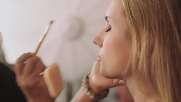 Portrait of girl in makeup studio,Girl make-up artist applies makeup,Beauty concept.