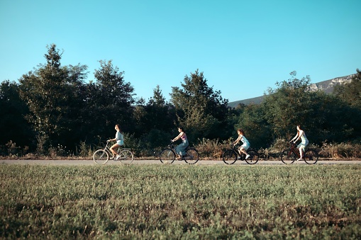 Group of women riding bikes and enjoying their free time in the nature