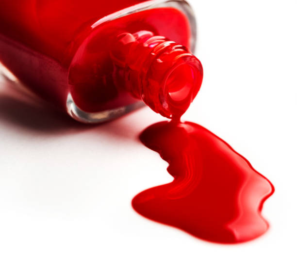 istock Pouring nail polish from bottle 1648748232