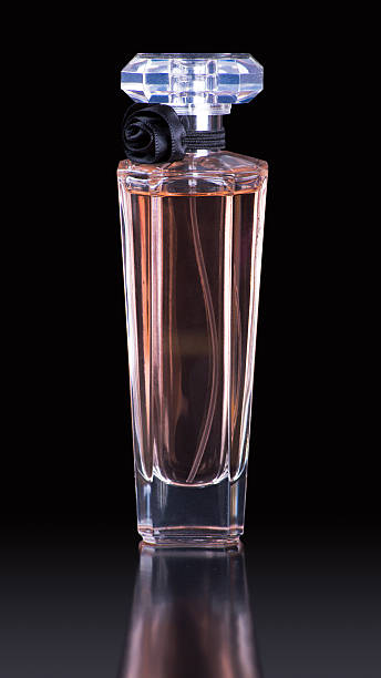 Perfume bottle on black background with reflection