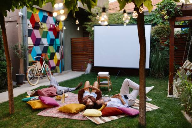 istock Multiracial friends watching a movie in the backyard 1648756944