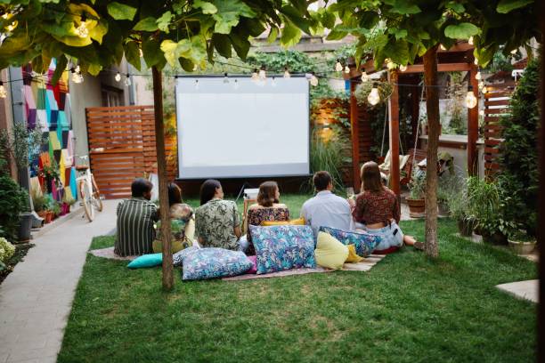 istock Friends watching a movie on a projection screen 1648760260