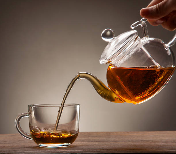 istock poured from a teapot cup of tea on a wooden table 1648775128