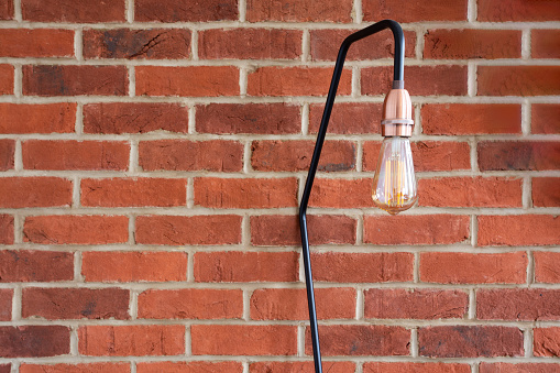 A stylish lamp on a brick wall