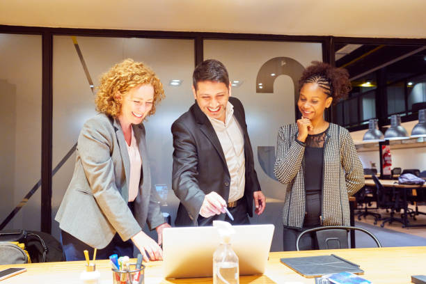 istock portrait three multiracial employees in meeting room looking at a notebook and smiling 1648790375