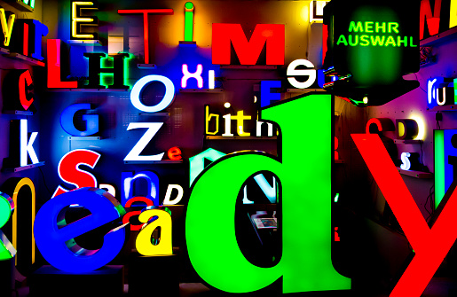 Many colorful and illuminated letters and words in a shop window display