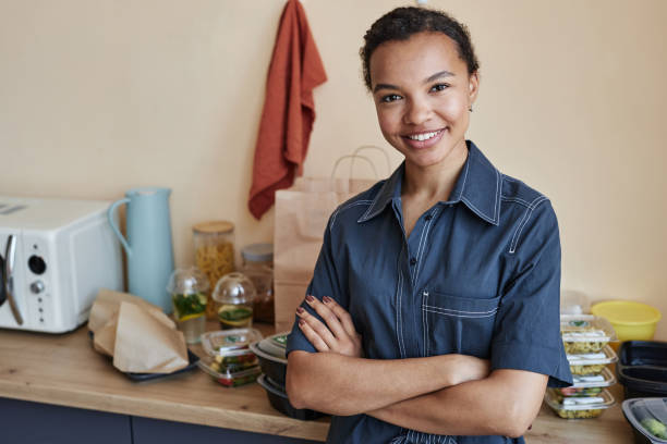 istock Smiling young Black woman standing in kitchen 1648836012