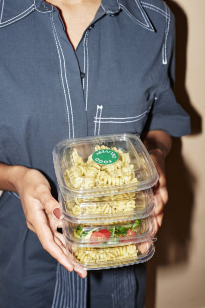 istock Young woman holding food in plastic containers 1648836017