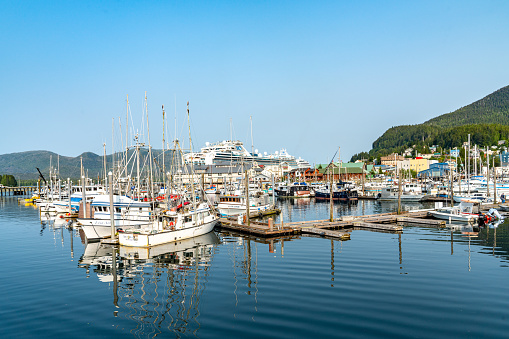 Rear view of fishing boat going into Viavélez harbor,  sea water,stone cliff in the  background. Asturias, Spain.