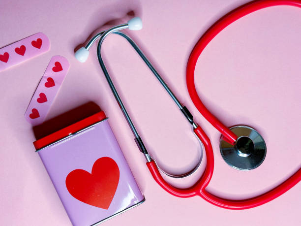 pink background with stethoscope and medical plasters with hearts - gland lobule imagens e fotografias de stock