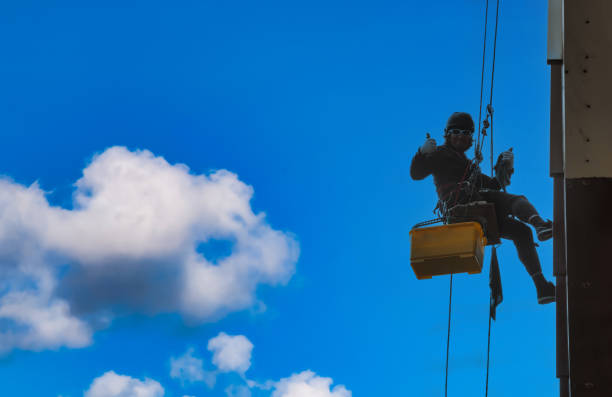 istock Industrial mountaineering worker hangs over residential facade 1648865310
