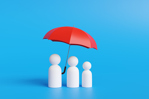 White peg people grouped together as a family under a red umbrella on blue background. Illustration of the concept of family protection plan