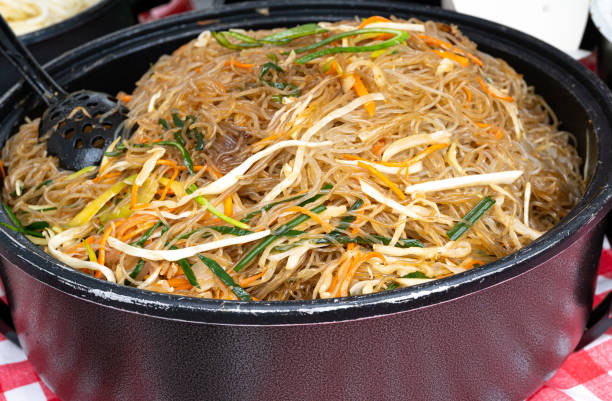 Glass Noodle Salad Street Food, Chinese Rice Noodles in Wok, Asian Pasta Food in a Large Pot, Korean Spaghetti Glass Noodle Salad Street Food, Chinese Rice Noodles in Wok, Asian Pasta Food in a Large Pot, Korean Spaghetti, Vietnamese Udon with Vegetables and Spices large pasta pot stock pictures, royalty-free photos & images