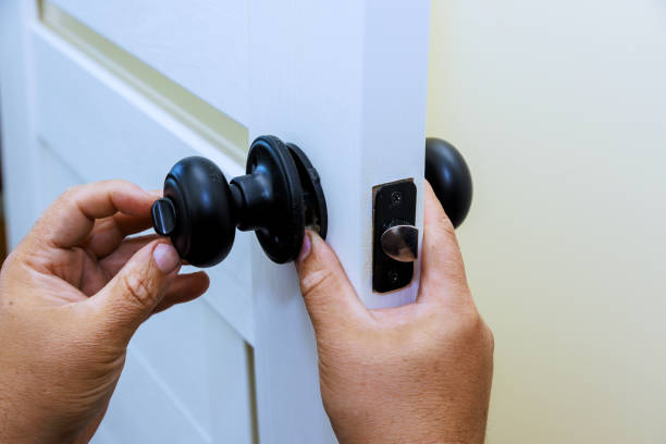 istock Worker employs a screwdriver to secure lock onto freshly installed interior door. 1648927703
