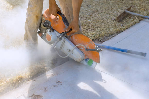 istock Precision Concrete Paving Sidewalk Cutting by Skilled Construction Worker with Diamond Blade Saw 1648929184
