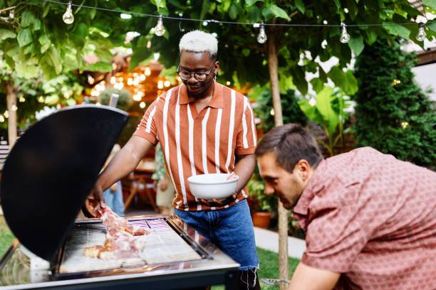 istock Friends preparing barbecue in the backyard 1648937843