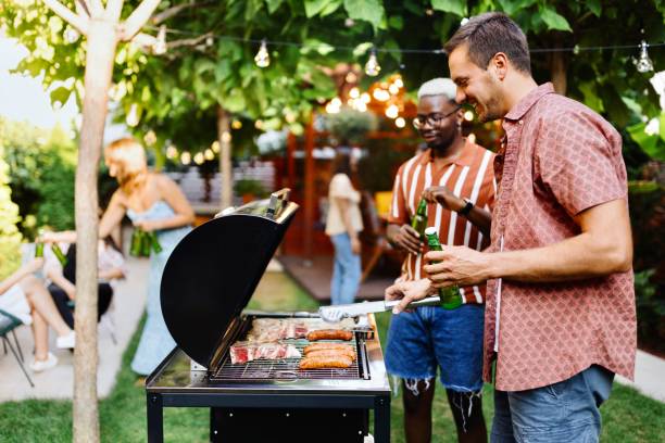istock Two friends talking and preparing a barbecue 1648938930