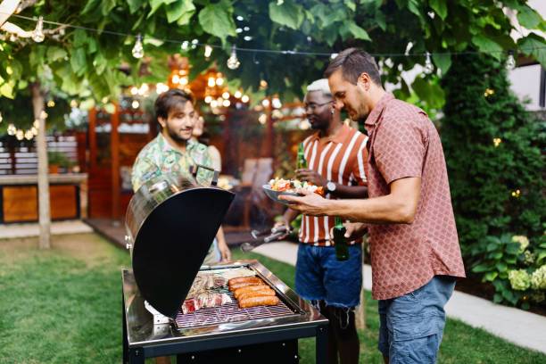 istock Men making a barbecue and enjoying in the backyard 1648939987