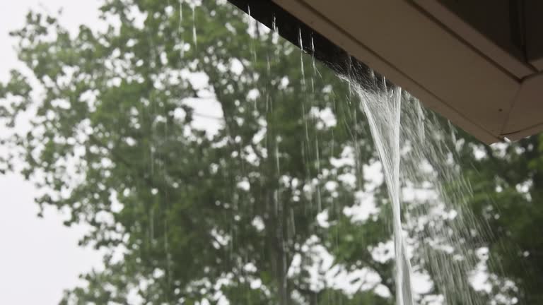 During a downpour, water escapes from the over gutters.