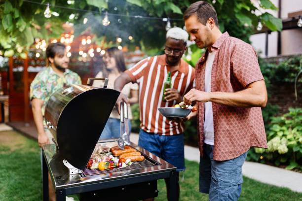 istock Multiracial friends preparing a barbecue on a beautiful day 1648940509