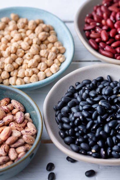 istock Different types of legumes in bowls - black beans 1648941572