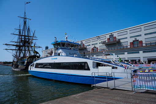 Gothenburg, Sweden - June 03 2023: Hybrid electric ferry Eloise by the indiaman replica Gotheborg.