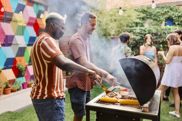 istock Multiracial friends preparing food in the backyard 1648945922