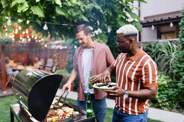 istock Good friends preparing some food in the backyard 1648949152