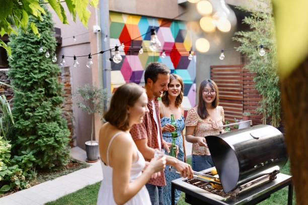 istock Multiracial friends preparing a barbecue in the backyard 1648958436