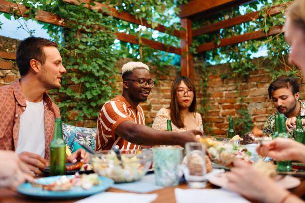 istock Multiracial people eating and drinking in the backyard 1648960123