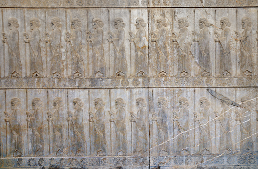 Ancient wall with bas-relief with assyrian warriors with spears, Persepolis, Iran. UNESCO world heritage site