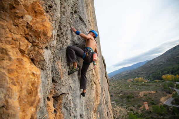 istock Shirtless climber man climbing mountain wall on amazing sunny day 1648973515