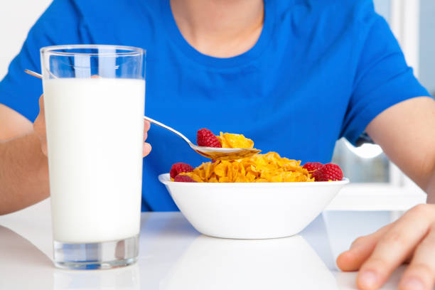 Splashing milk in a bowl of cereal and fruits