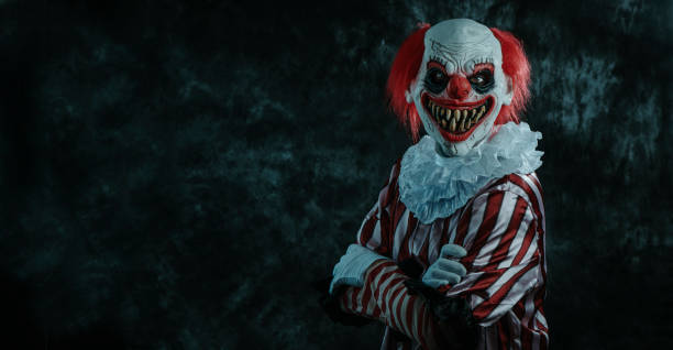 istock mad cross-armed redhead clown on a dark background 1649007690