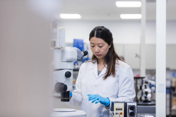 istock Female scientist uses pipette to prepare a slide for viewing 1649008215